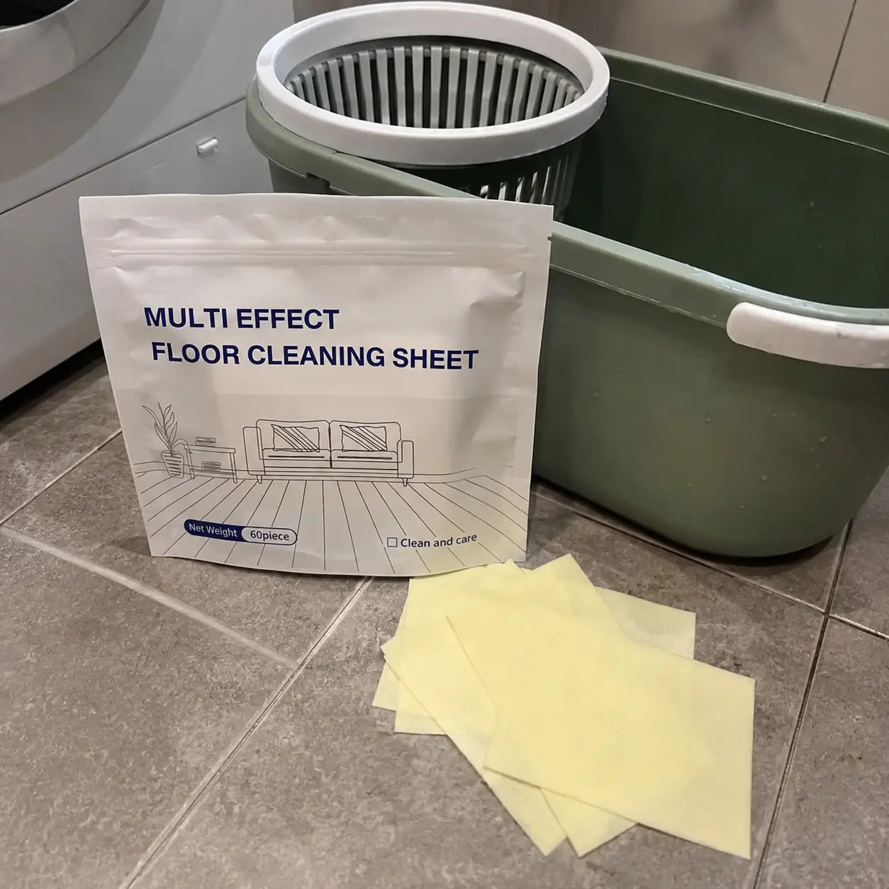 Floor cleaning sheet package and yellow sheets beside a mop bucket