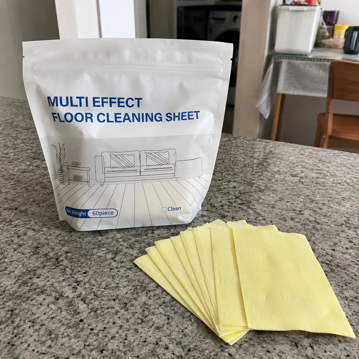Floor cleaning sheet package with yellow sheets on a kitchen counter